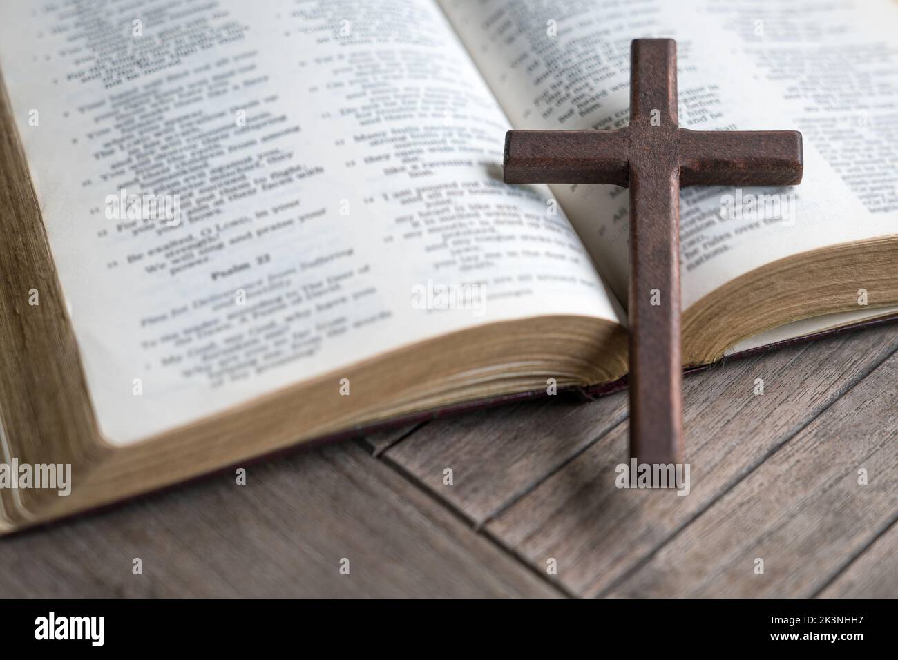 Wooden cross on top of an open bible. Copy space. Stock Photo