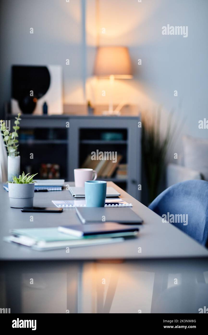 Vertical background image of modern home interior with workplace in dark blue colors Stock Photo