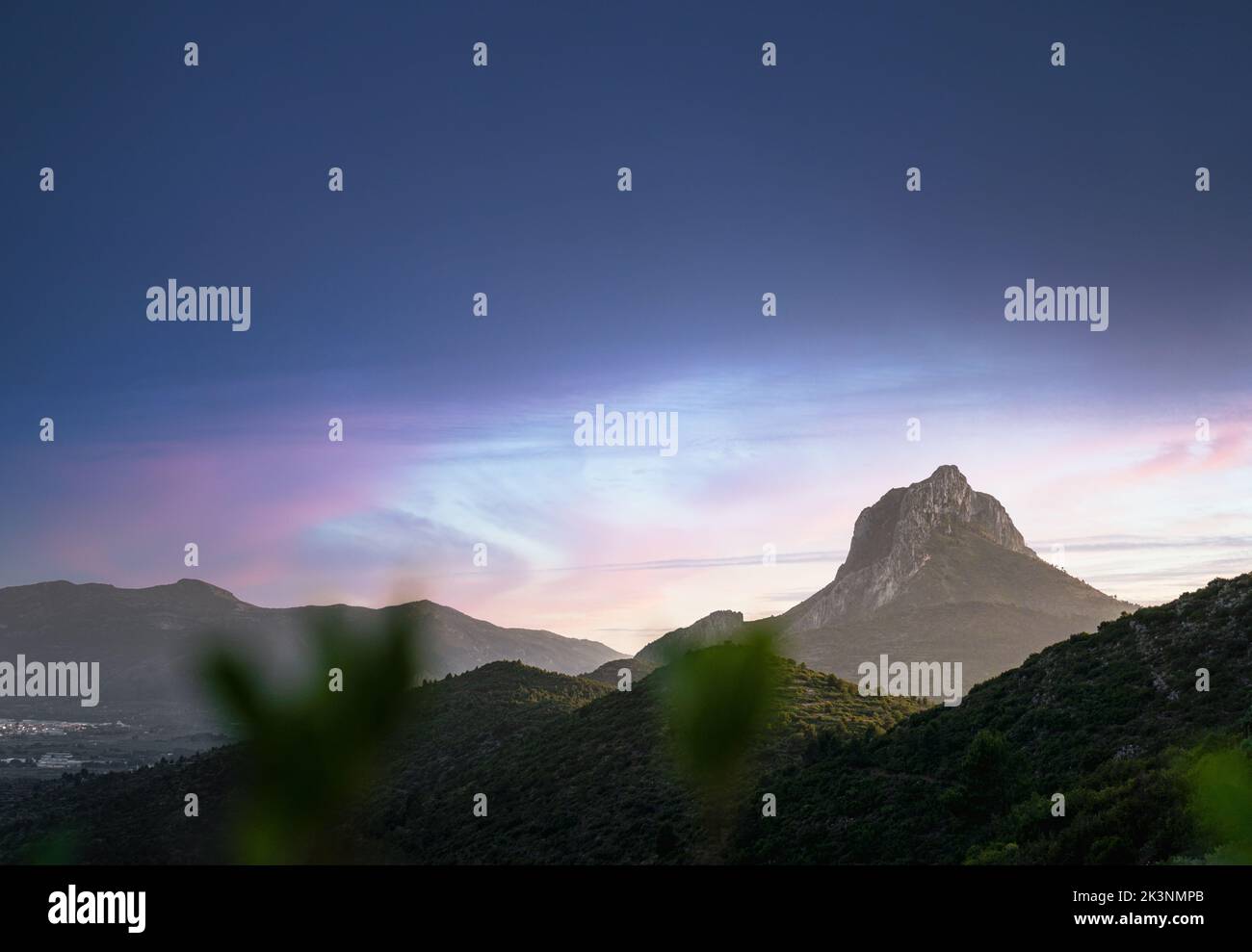 The view of the mountainscape before the Pena de Bernal under the blue sky in Mexico Stock Photo