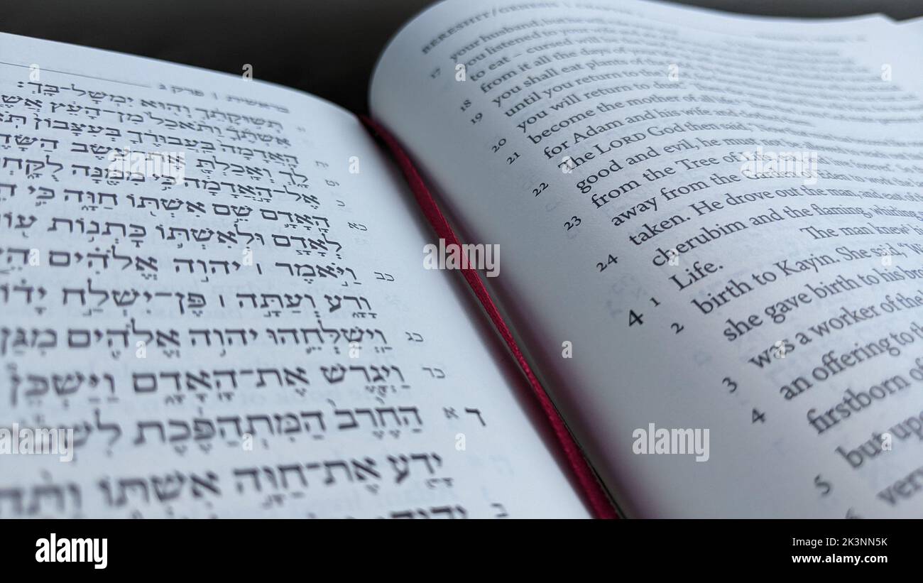 A closeup shot of the Hebrew Bible with an English translation on the side Stock Photo