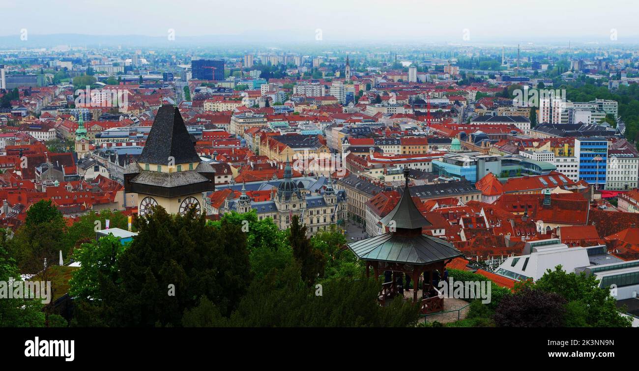 An aerial shot of the Uhrturm landscape in Graz, Austria with a cityscape in the background Stock Photo