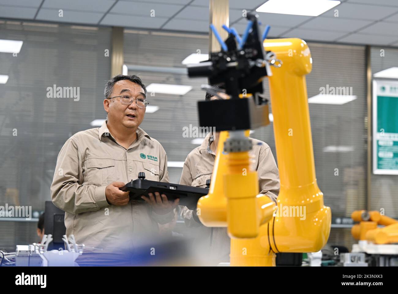 Tianjin. 8th Sep, 2022. Zhang Liming and his colleague adjust a fourth-generation robot in north China's Tianjin, Sept. 8, 2022. Zhang Liming, a delegate to the upcoming 20th National Congress of the Communist Party of China (CPC), is well-known for his innovative prowess. TO GO WITH 'Profile: A CPC national congress delegate pursuing innovation' Credit: Zhao Zishuo/Xinhua/Alamy Live News Stock Photo