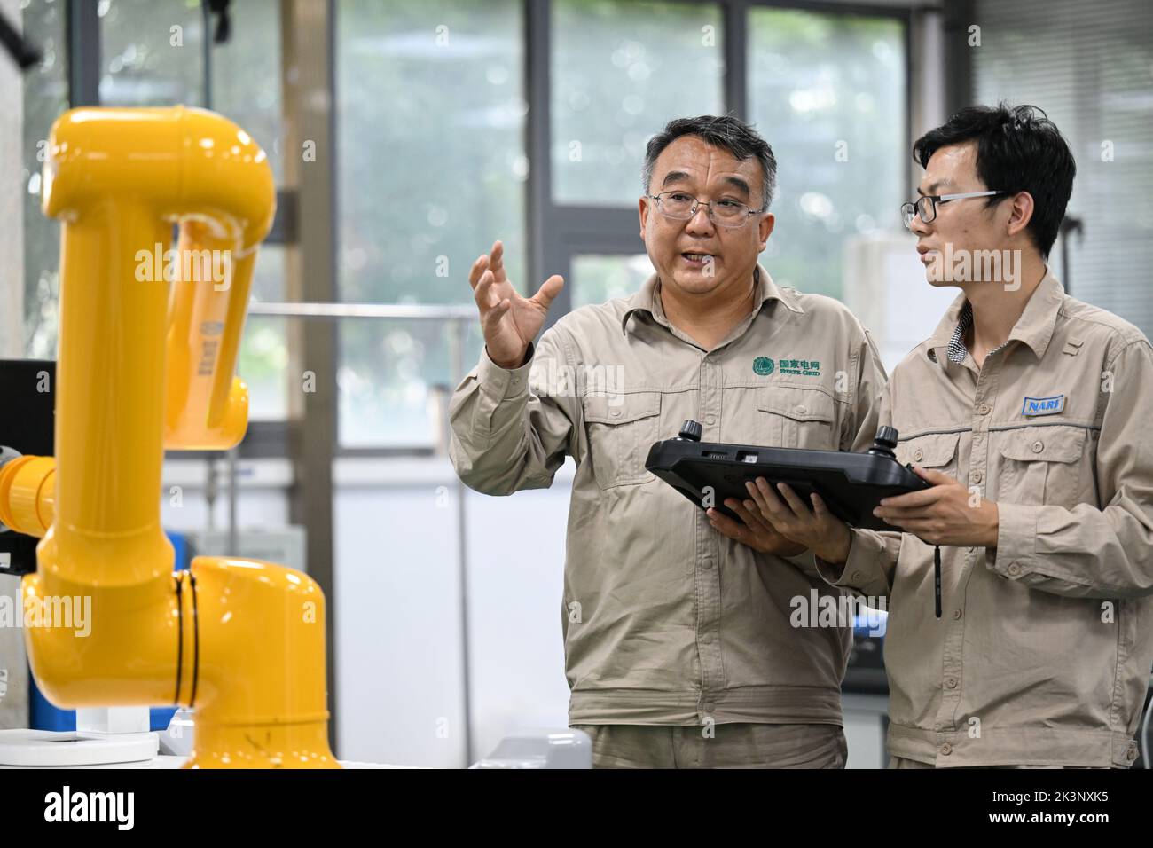 Tianjin. 8th Sep, 2022. Zhang Liming (L) and his colleague adjust a fourth-generation robot in north China's Tianjin, Sept. 8, 2022. Zhang Liming, a delegate to the upcoming 20th National Congress of the Communist Party of China (CPC), is well-known for his innovative prowess. TO GO WITH 'Profile: A CPC national congress delegate pursuing innovation' Credit: Zhao Zishuo/Xinhua/Alamy Live News Stock Photo