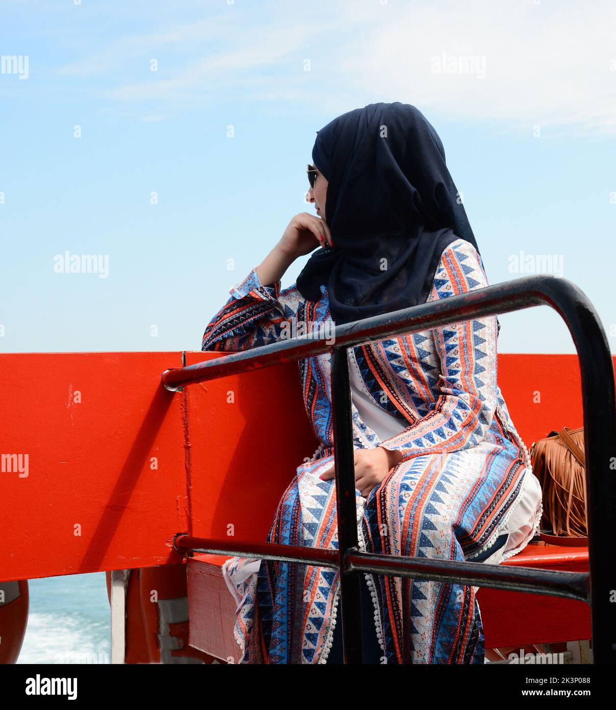 Istanbul, Turkey - May 9th 2016: A woman sitting on the bench looking ...