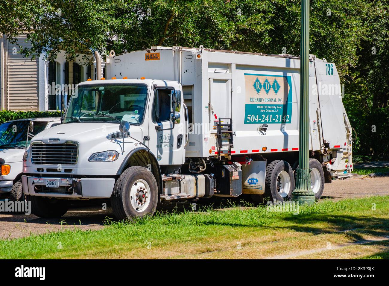 NEW ORLEANS, LA, USA - SEPTEMBER 27, 2022: Richard's Disposal Company garbage truck picking up trash on St. Charles Avenue Stock Photo