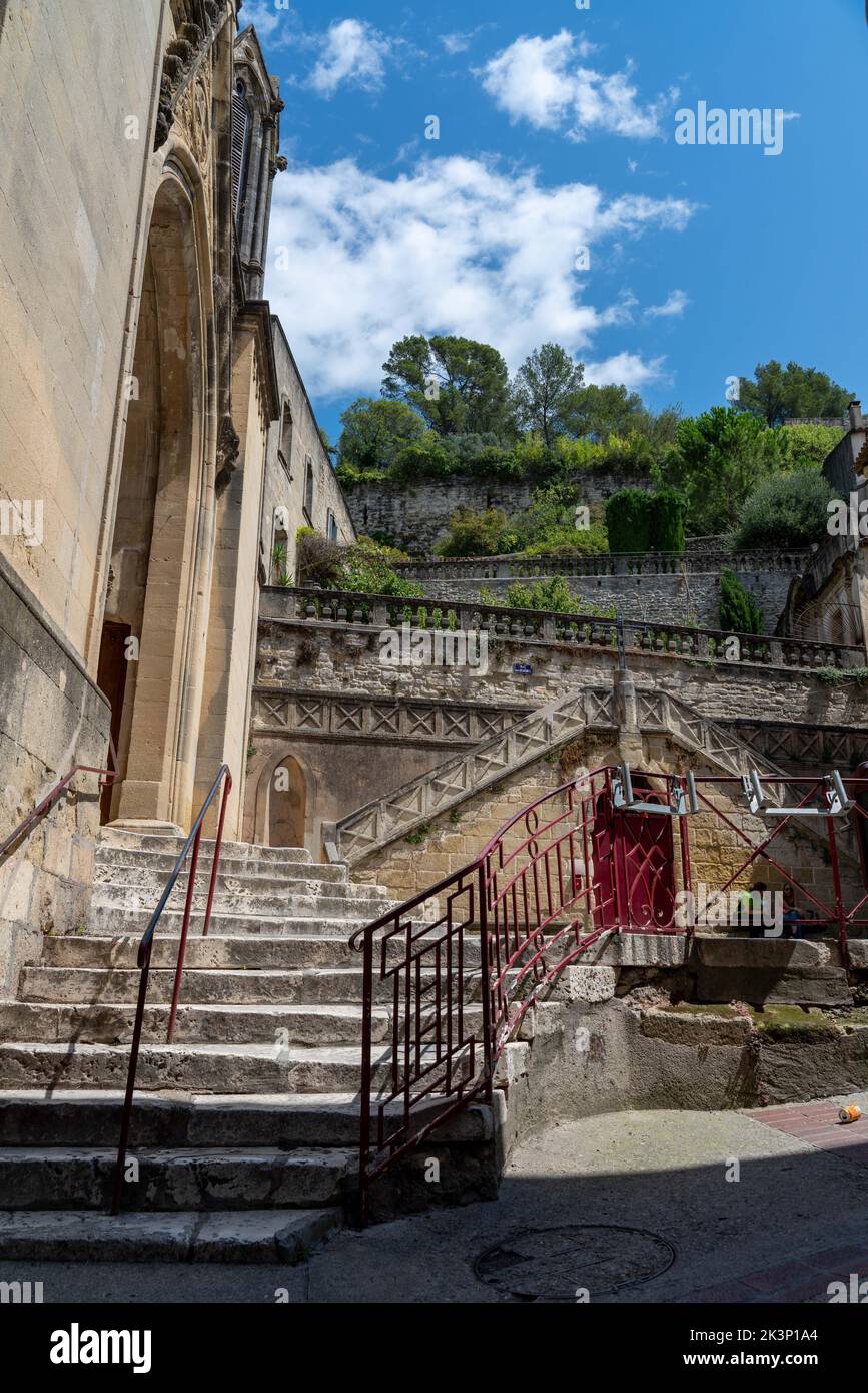 A vertical shot of a staircase on a sunny day in Sommieres, Gard, France Stock Photo