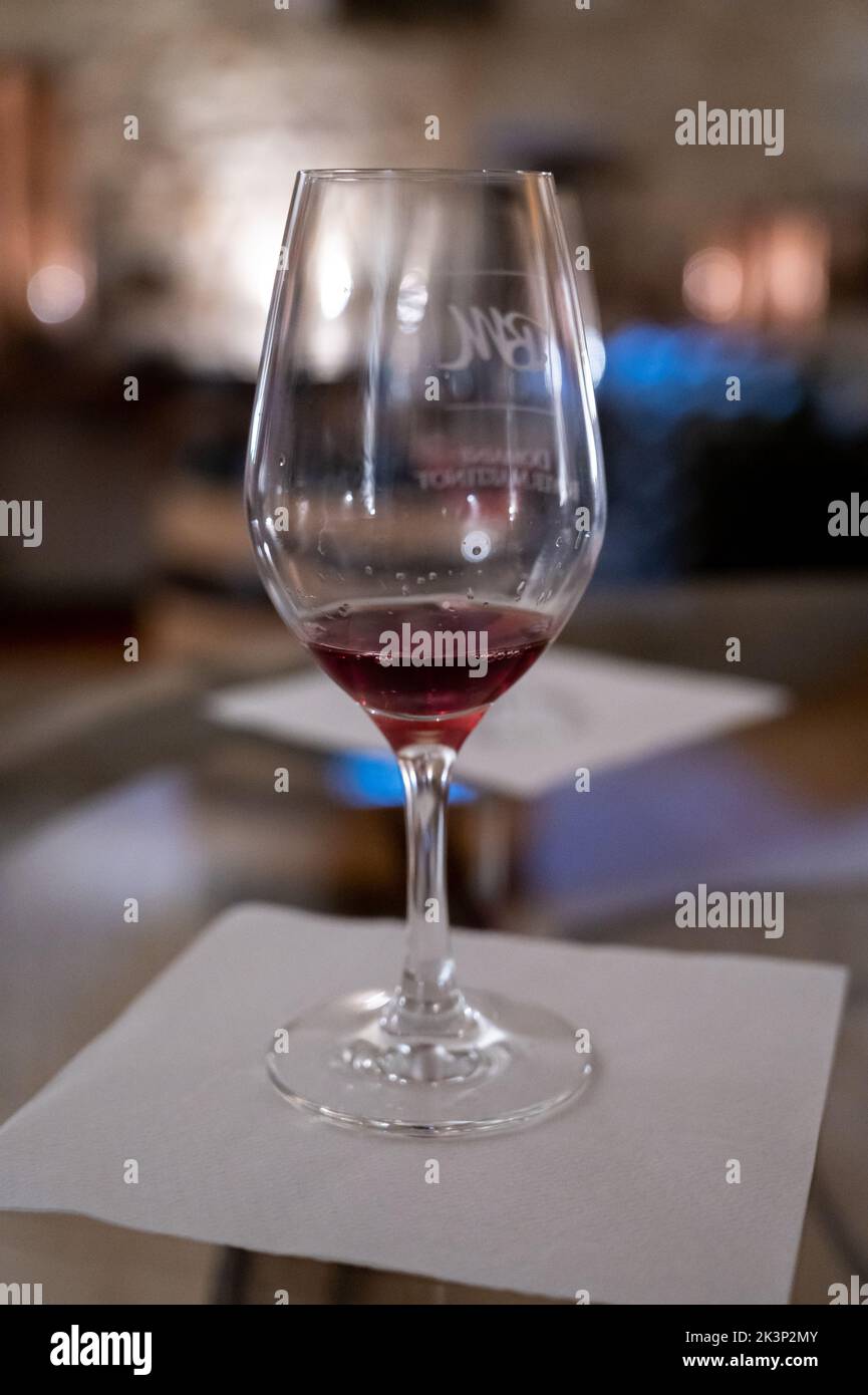 Red wine tasting in underground cellars caves of French wine domain in