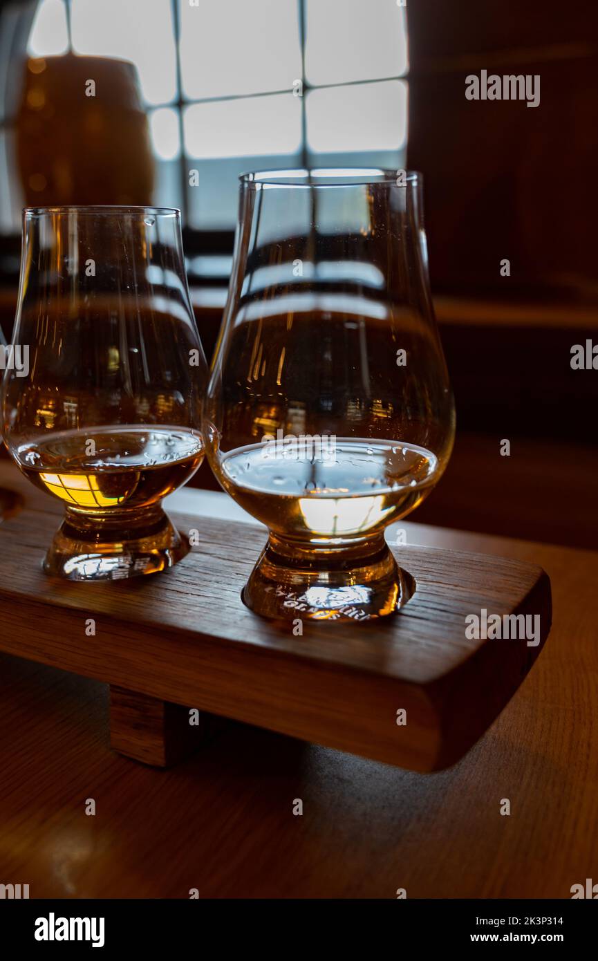Flight of single malt scotch whisky in glasses served in bar in