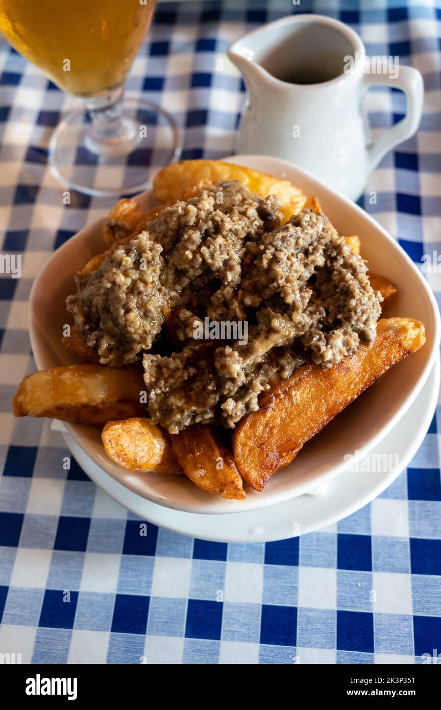 Scottish traditional snack food, hand cut potato chips topped with