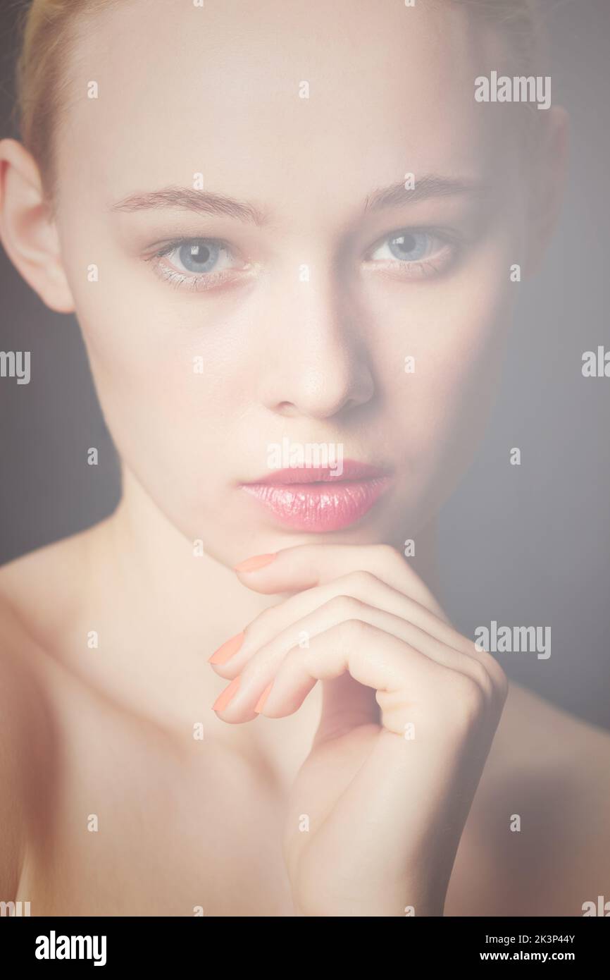 Mysterious beauty. Beauty shot of a young blond woman wearing red lipstick. Stock Photo
