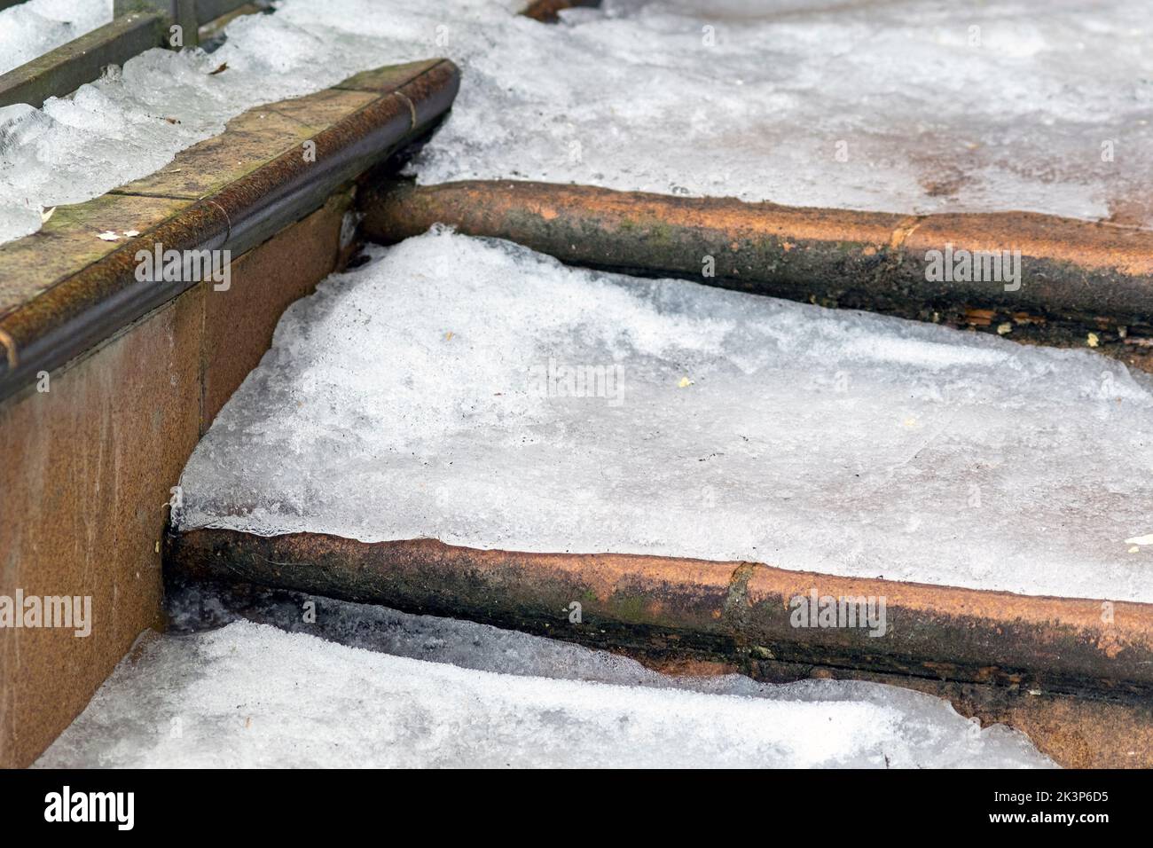 winter daytime outdoor shot of slippery stone steps covered with ice