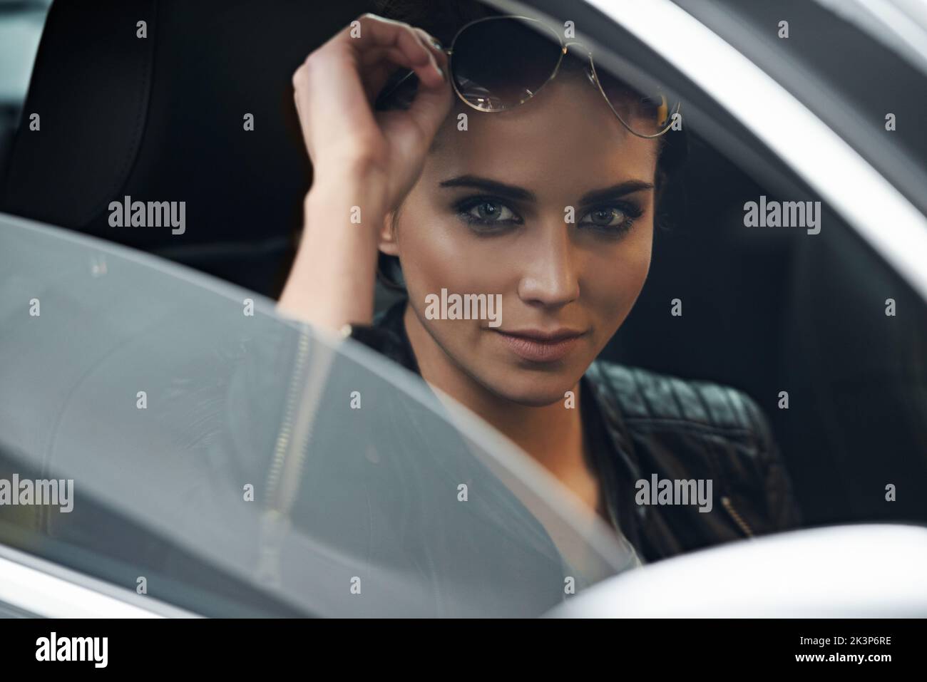 Where to go...an attractive young driver looking through the front windshield. Stock Photo