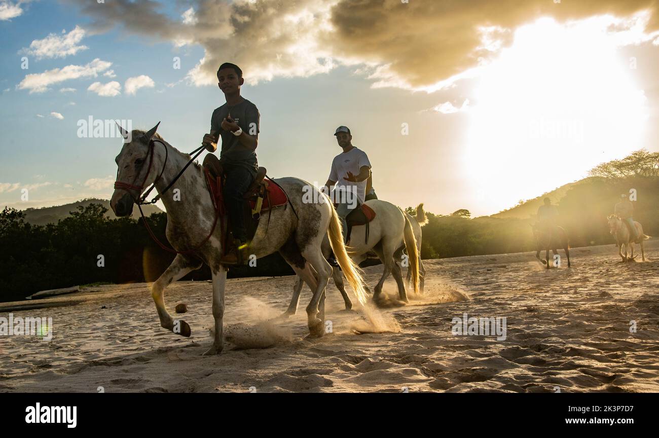 Horse riding on Playa Conchal, Guanacaste, Costa Rica Stock Photo