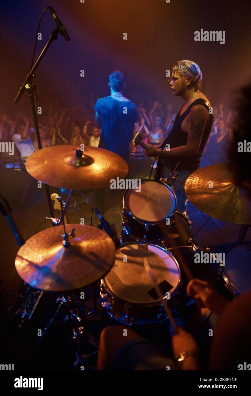 Performing the gig of a lifetime. Rear view of a band performing on stage at a music festival. Stock Photo