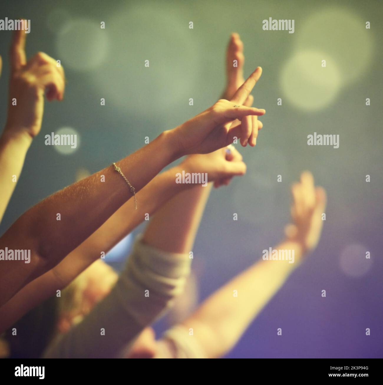 Reaching out to the performers. Cropped image of hands raised and reaching towards the stage gesturing rock on. Stock Photo