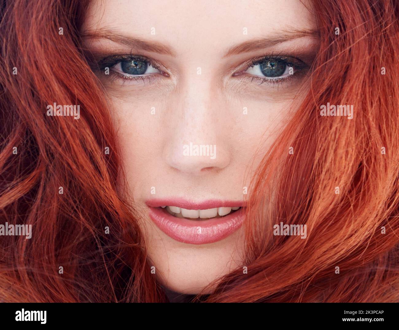Ginger goddess. A gorgeous young redheaded woman standing outside Stock