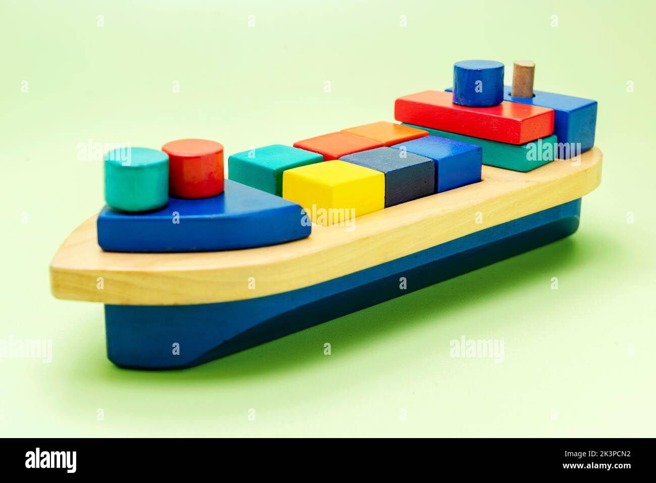 A colorful wooden toy ship on a colored background Stock Photo