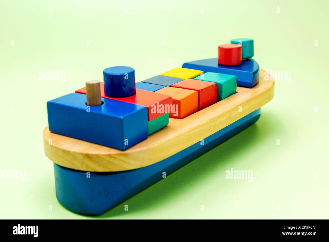 A colorful wooden toy ship on a colored background Stock Photo