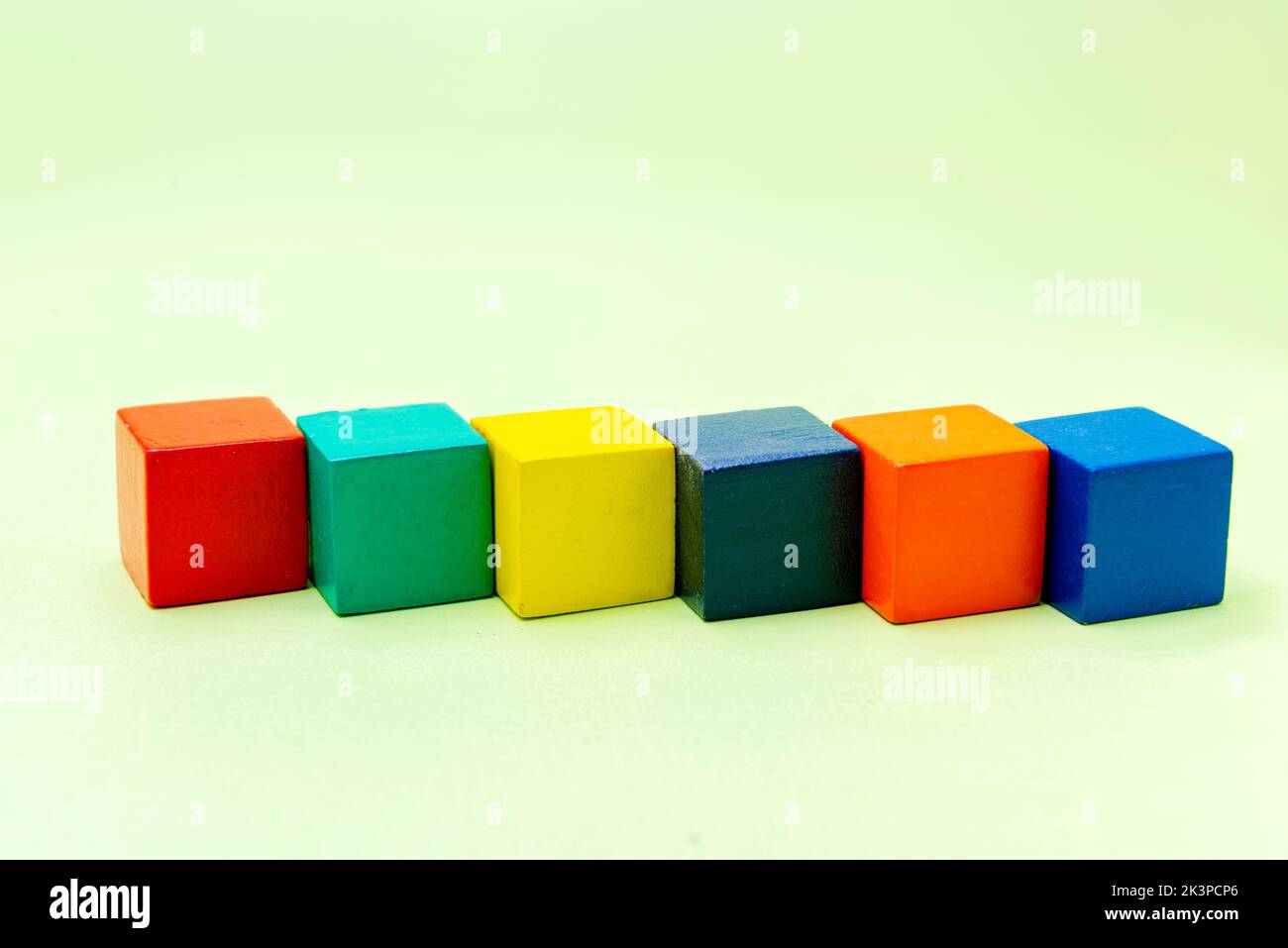 Colorful wooden block toys on a colored background Stock Photo