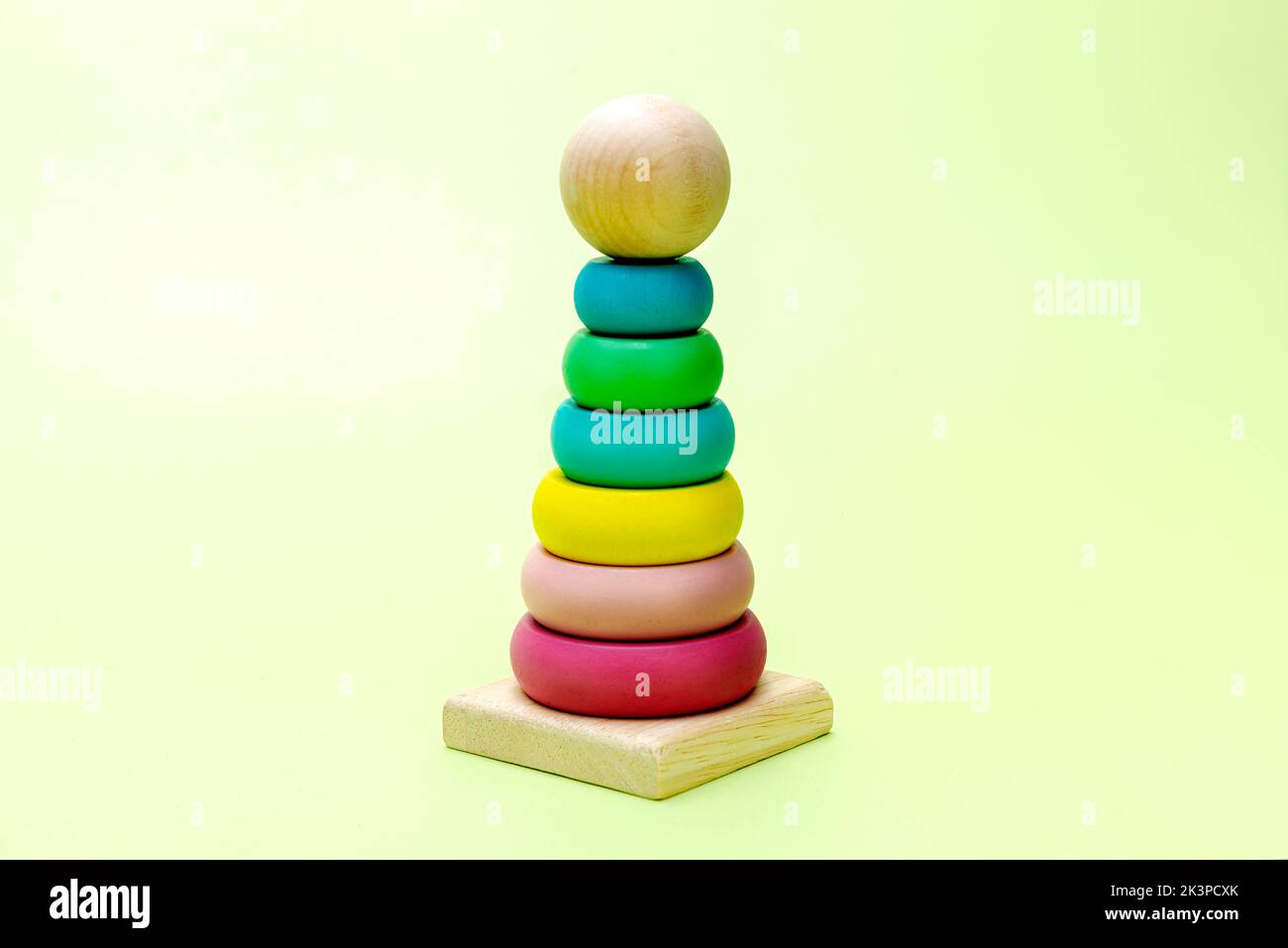 Colorful wooden pyramid toy on a colored background Stock Photo