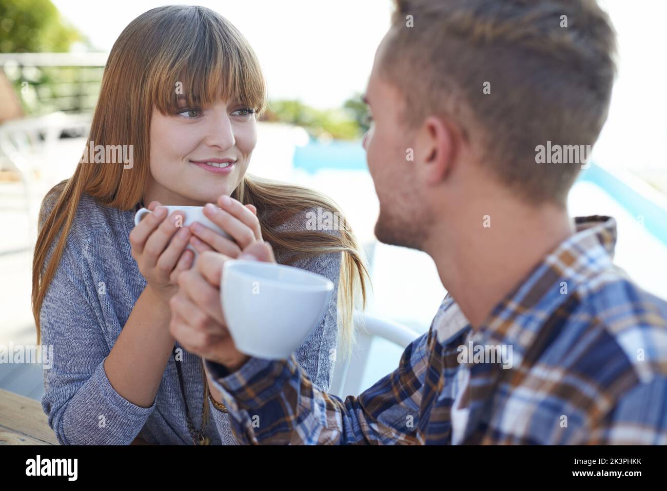 The perfect way to start the day is with you. A young couple enjoying breakfast outside. Stock Photo