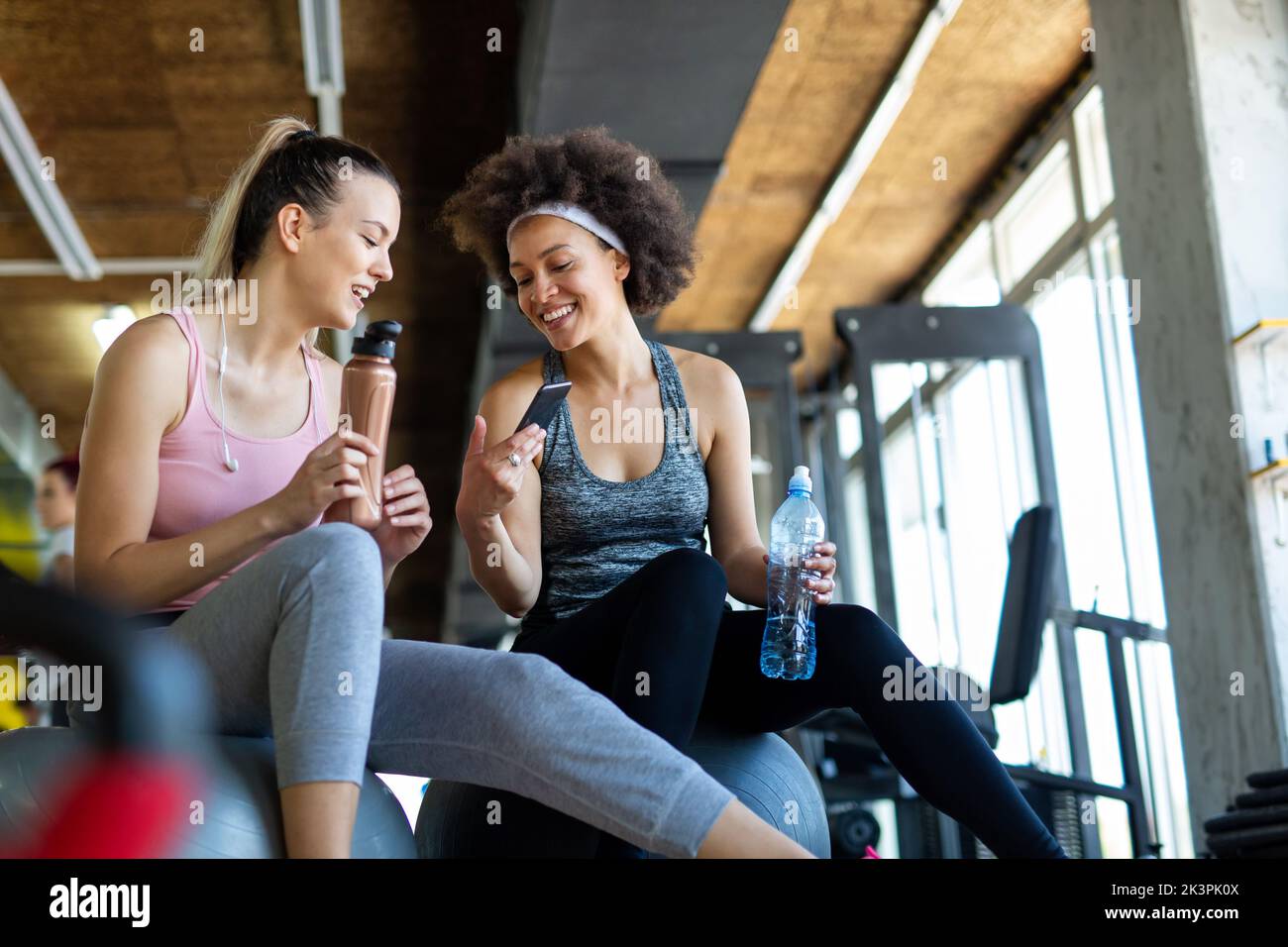 Beautiful women working out in gym together to stay healthy. Sport, people, friend concept. Stock Photo