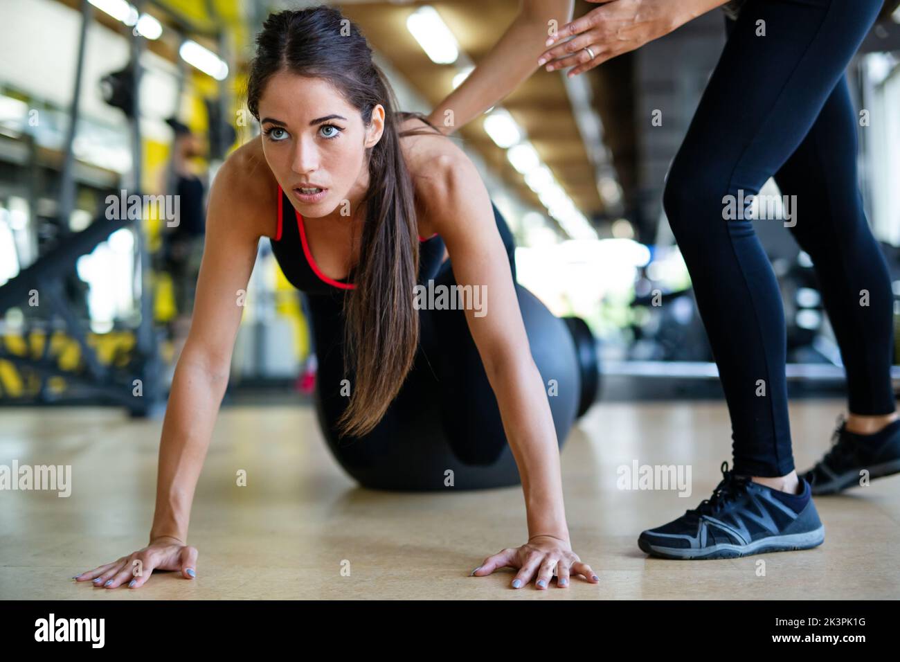 Beautiful fit women, friends working out in gym together. Sport, people concept Stock Photo