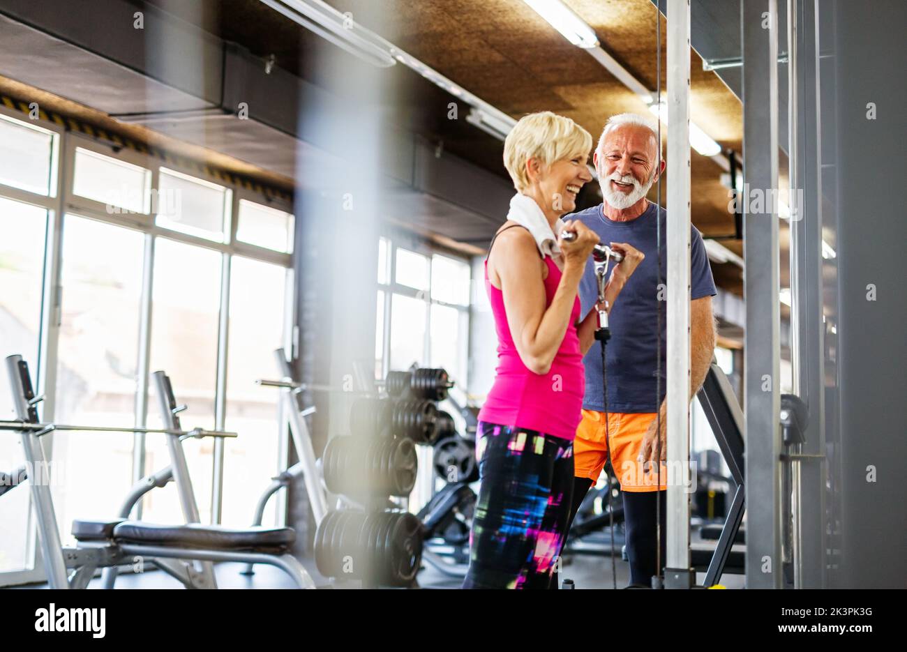 Senior fit man and woman doing exercises in gym to stay healthy Stock Photo