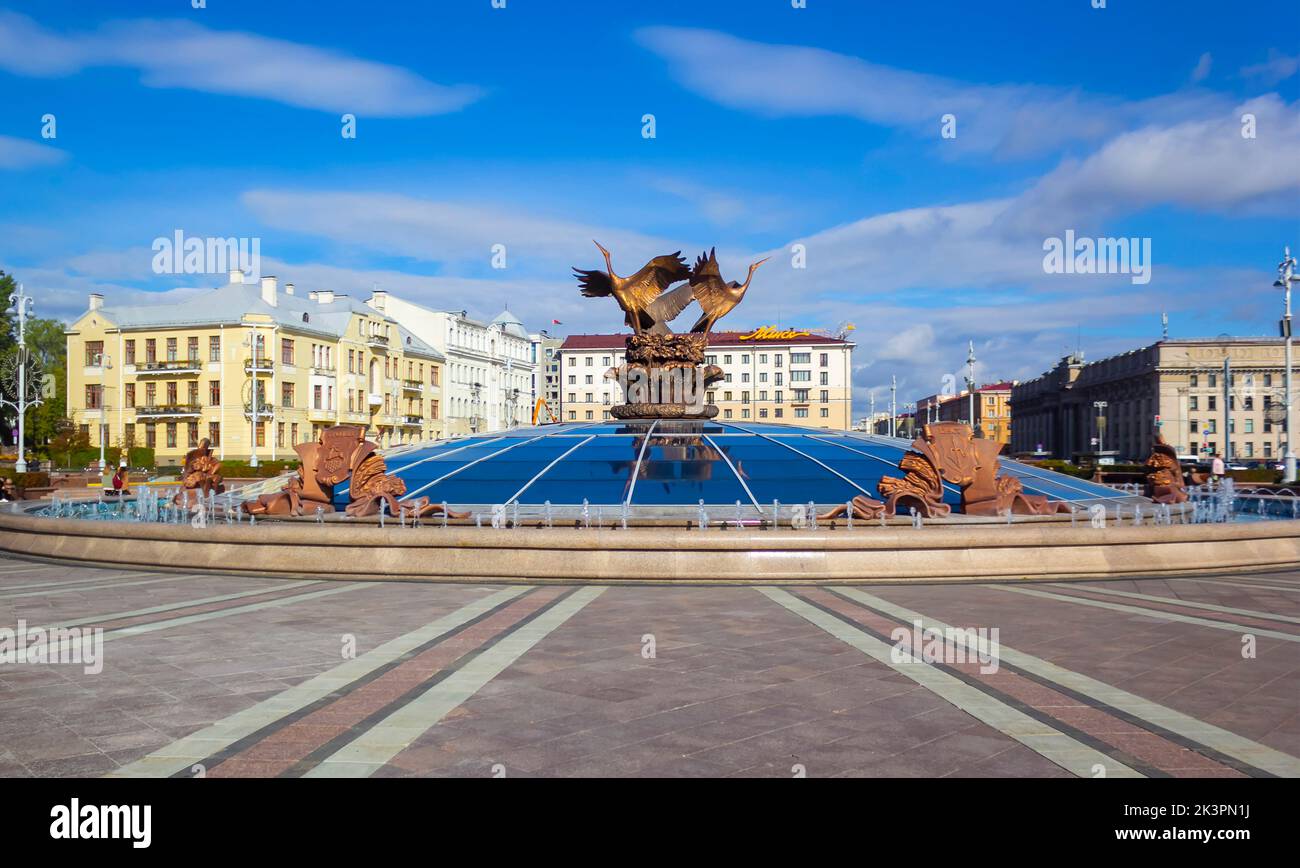 Fountain and sculptural composition Three storks on the dome. Independence Square. Minsk. Belarus. 09.24.2022. Coats of arms of regional cities of Bel Stock Photo