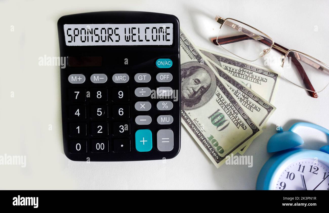 SPONSORS WELCOME text on calculator display with dollar banknotes, glasses and watch on white background Stock Photo