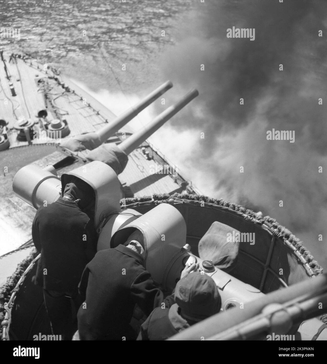 During World war II. The war ship Sverige during navy exercises at sea. The front cannons being fired and smoke is seen coming out of them. Sweden june 1940. Kristoffersson ref 141 Stock Photo