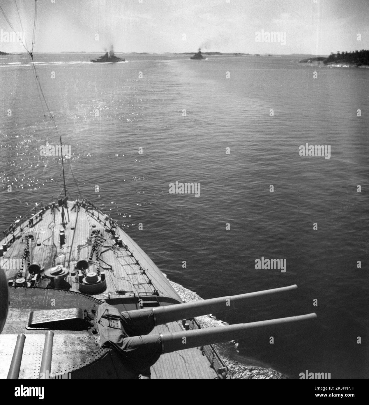 During World war II. The war ship Sverige during navy exercises at sea. The front cannons are visible with a swedish warships cruising on the side. Sweden june 1940. Kristoffersson ref 141 Stock Photo
