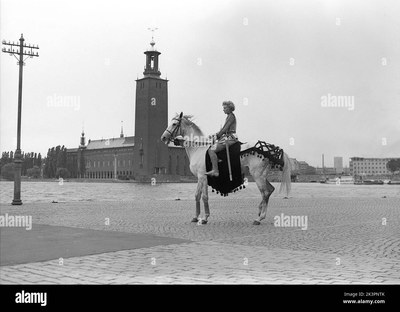 In the 1940s. The american movie Jeanne d'Arc is being promoted for it's premiere screening and Kerstin Bergo was chosen to act as Ingrid Bergman in the pr-stunt. She both looked a bit like Ingrid Bergman and could ride. In the background Stockholm city hall.  Stockholm Sweden 1949. Kristoffersson ref AO17-8 Stock Photo