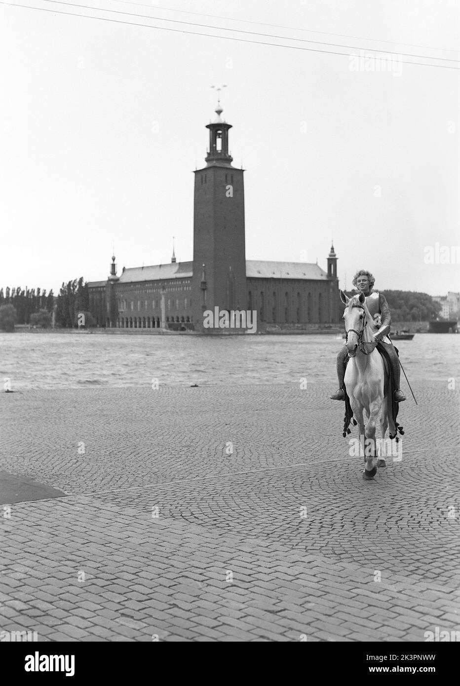 In the 1940s. The american movie Jeanne d'Arc is being promoted for it's premiere screening and Kerstin Bergo was chosen to act as Ingrid Bergman in the pr-stunt. She both looked a bit like Ingrid Bergman and could ride. In the background Stockholm city hall.  Stockholm Sweden 1949. Kristoffersson ref AO18-2 Stock Photo