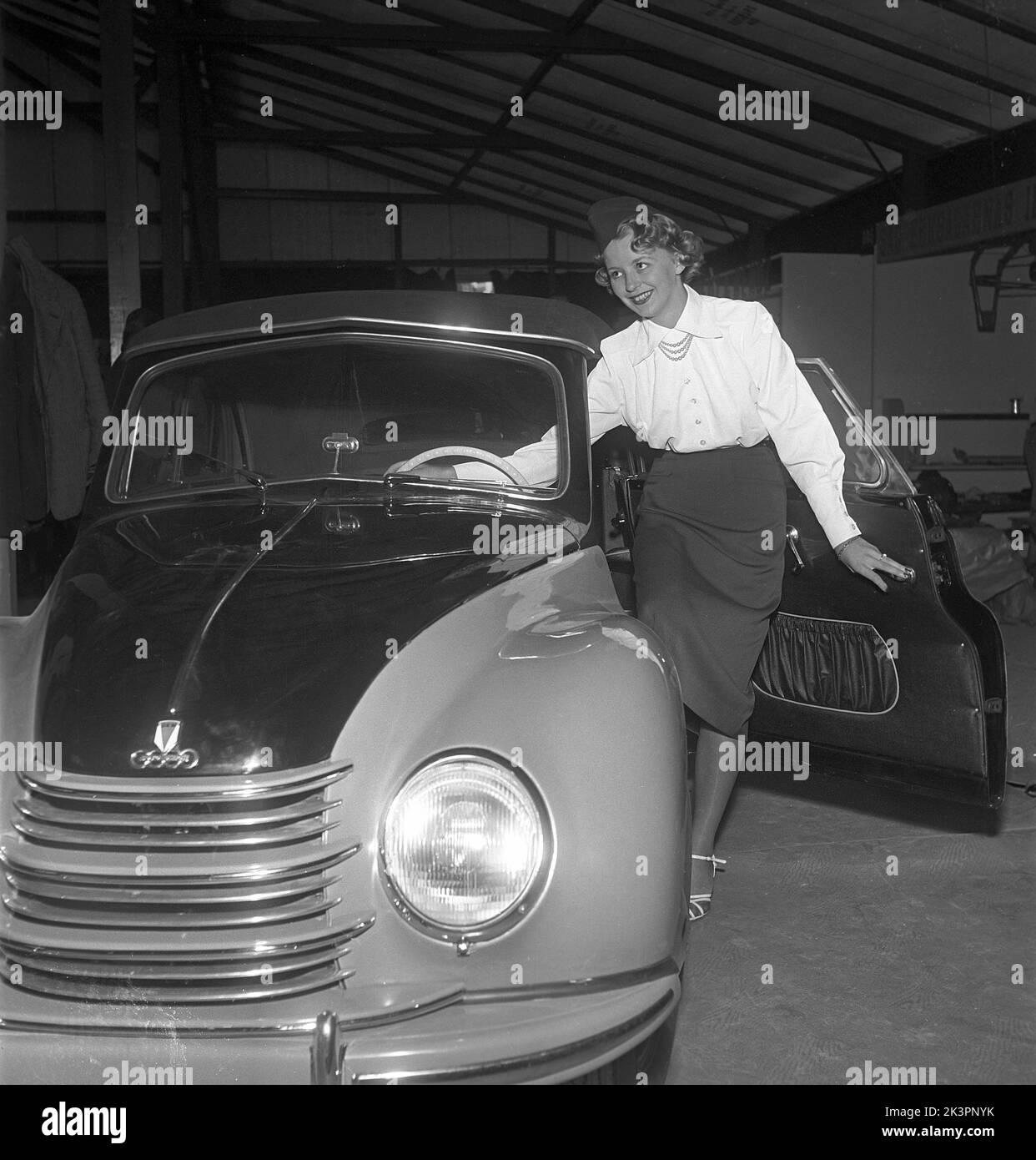 In the 1950s. A young woman on the hood of the brand new car, a DKW