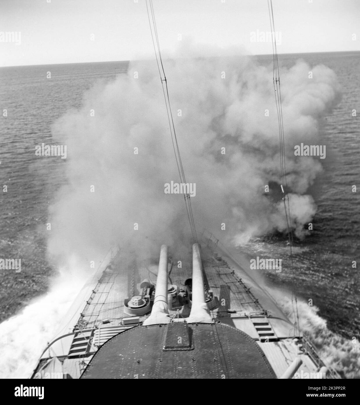 During World war II. The war ship Sverige during navy exercises at sea. The front cannons being fired and smoke is seen coming out of them. Sweden june 1940. Kristoffersson ref 141 Stock Photo