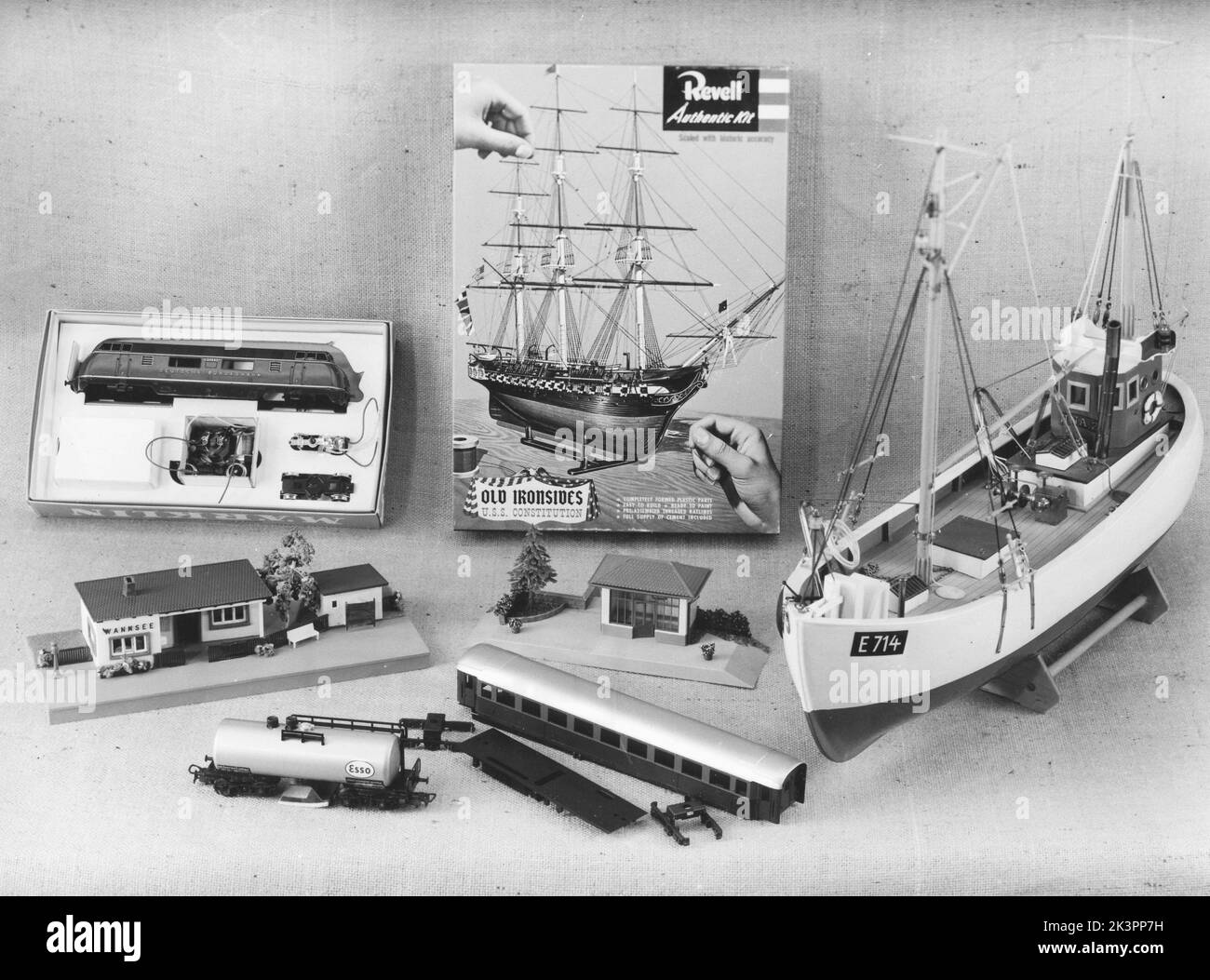 Hobby in the 1960s. Different popular scale models in a picture taken in 1962. Kit with Revell model of the ship Old Ironsides, Märklin trains and model railroad houses, a wooden trawler. All of them popular toys and hobbies during this time. Picture taken in december and before christmas in an article of popular christmas gifts for boys. Sweden 1962 Stock Photo