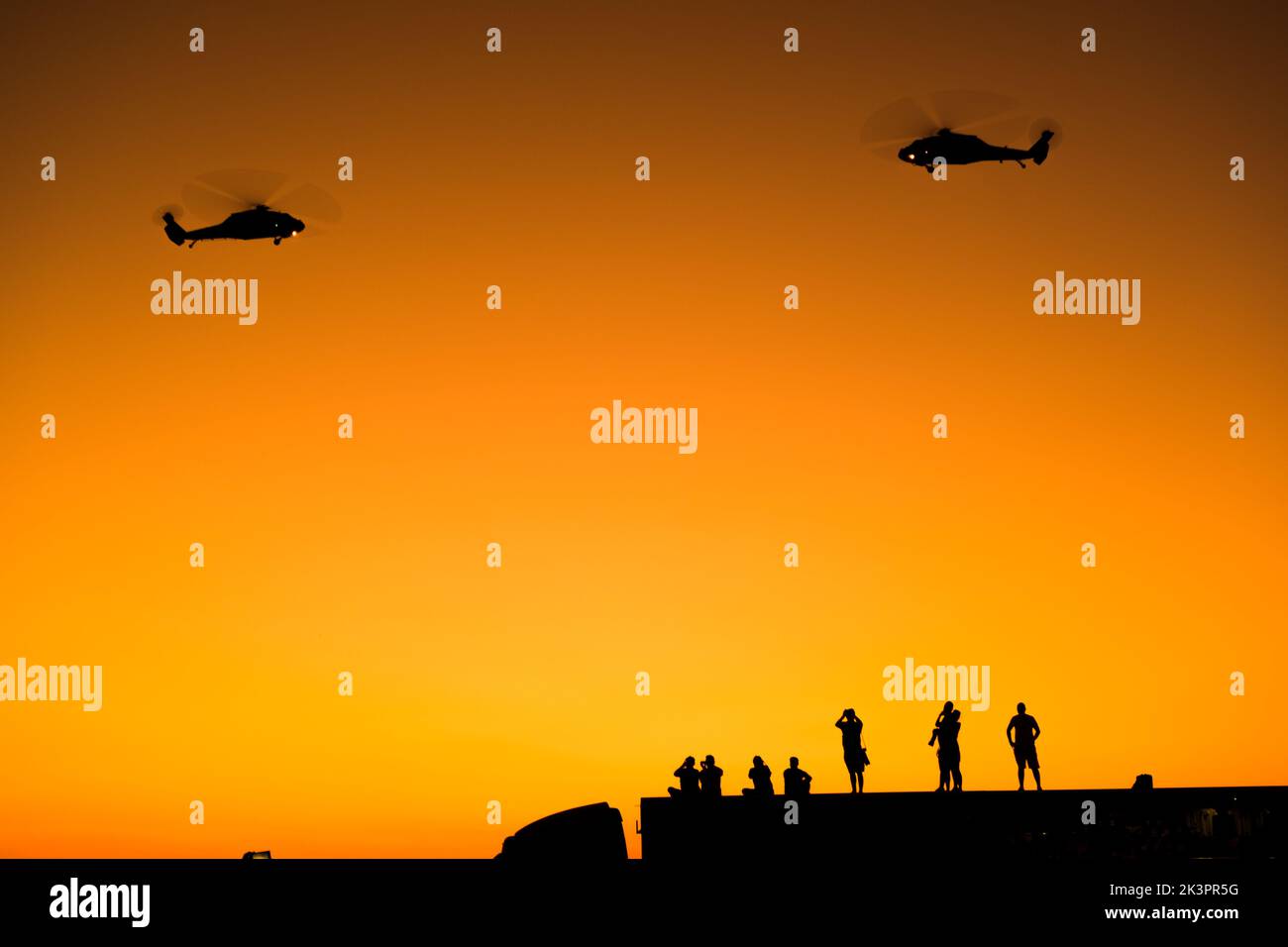 Izmir, Turkey - September 9, 2022: Silhouette of  Turkish gendarme helicopters on the sky with some photographers  on the liberty day of Izmir at Izmi Stock Photo