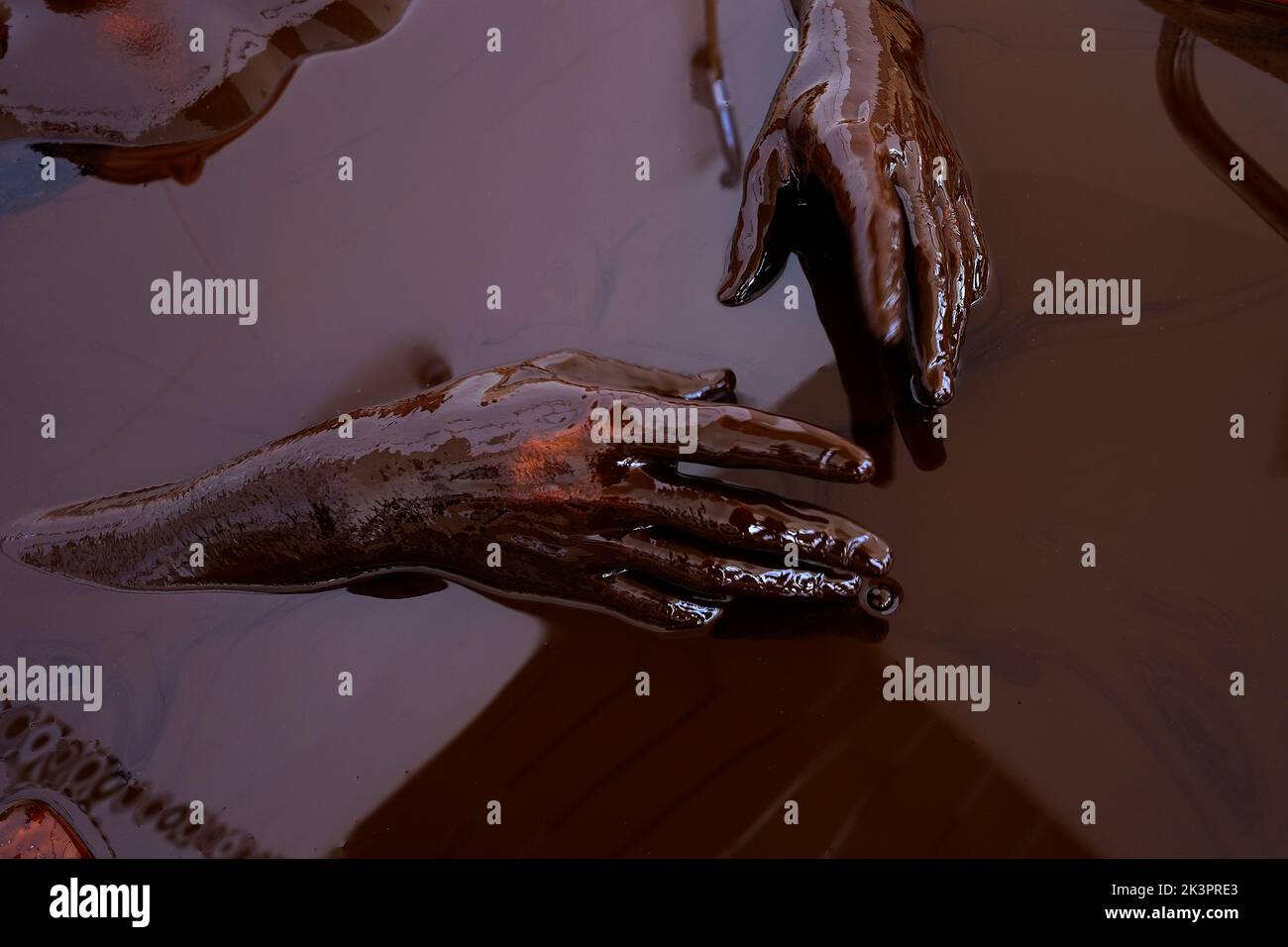 A man takes a ten minute crude oil bath offered as physical therapy in