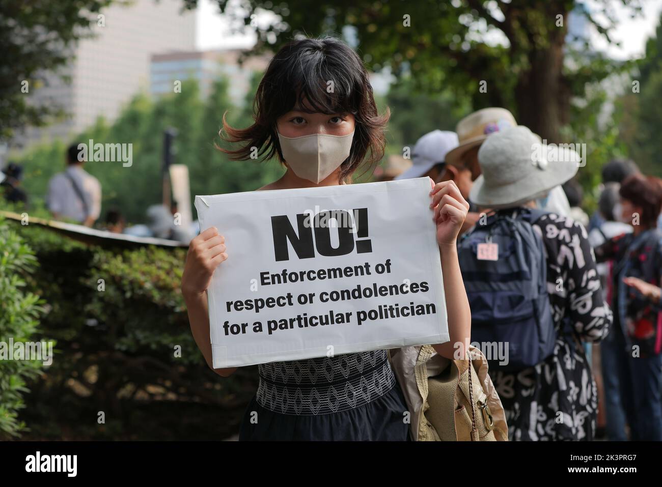 Tokyo, Japan. 27th Sep, 2022. A demonstrator holds a sign reading: 'NO! Enforcement of respect or condolences for a particular politician'. Demonstrators gathered in front of the National Diet Building (Tokyo) to express their dissatisfaction with the government's decision to give former Japanese Prime Minister Shinzo Abe a state funeral. They criticize the high costs and the late timing of the funeral. Credit: SOPA Images Limited/Alamy Live News Stock Photo