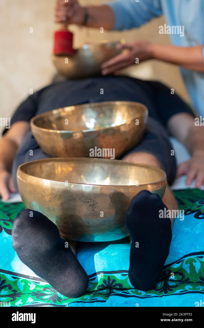Tibetan Bells Therapy, Singing Bowl in the Hands of a Therapist Stock Photo