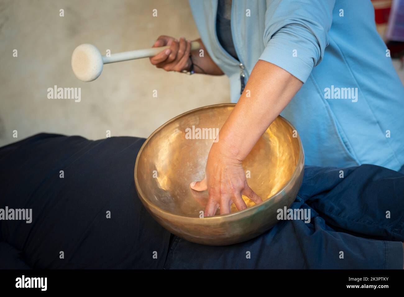 Tibetan Bells Therapy, Singing Bowl in the Hands of a Therapist Stock Photo