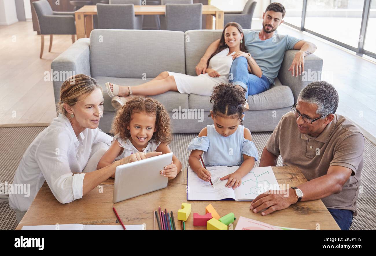 Family, education and grandparents helping kids with development learning schoolwork in drawing book and tablet. Old man and elderly woman teaching Stock Photo