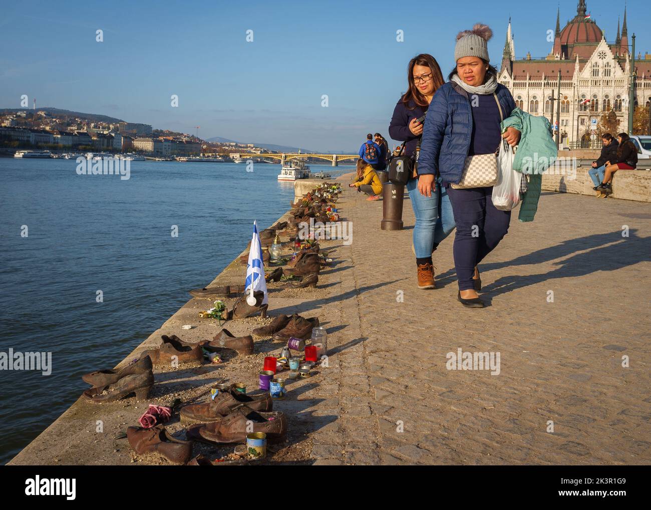 The tourists near Iron shoes memorial to Jewish people executed during WW2 in Budapest Stock Photo