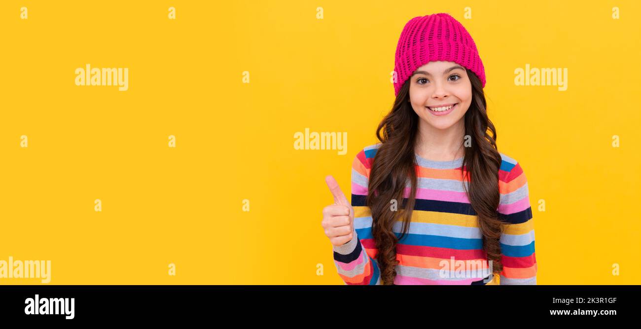 happy teen girl showing thumb up gesture, excellence. Child face, horizontal poster, teenager girl isolated portrait, banner with copy space. Stock Photo
