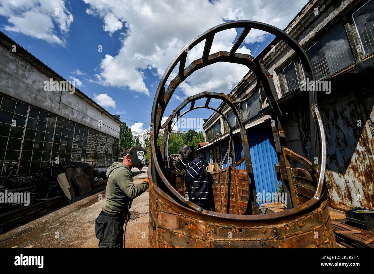 ZAPORIZHZHIA, UKRAINE - MAY 19, 2022 - Member of the Palianytsia Charity Foundation, welder Yevhen Blahun (L) works on the 2.5-tonne monument to the b Stock Photo