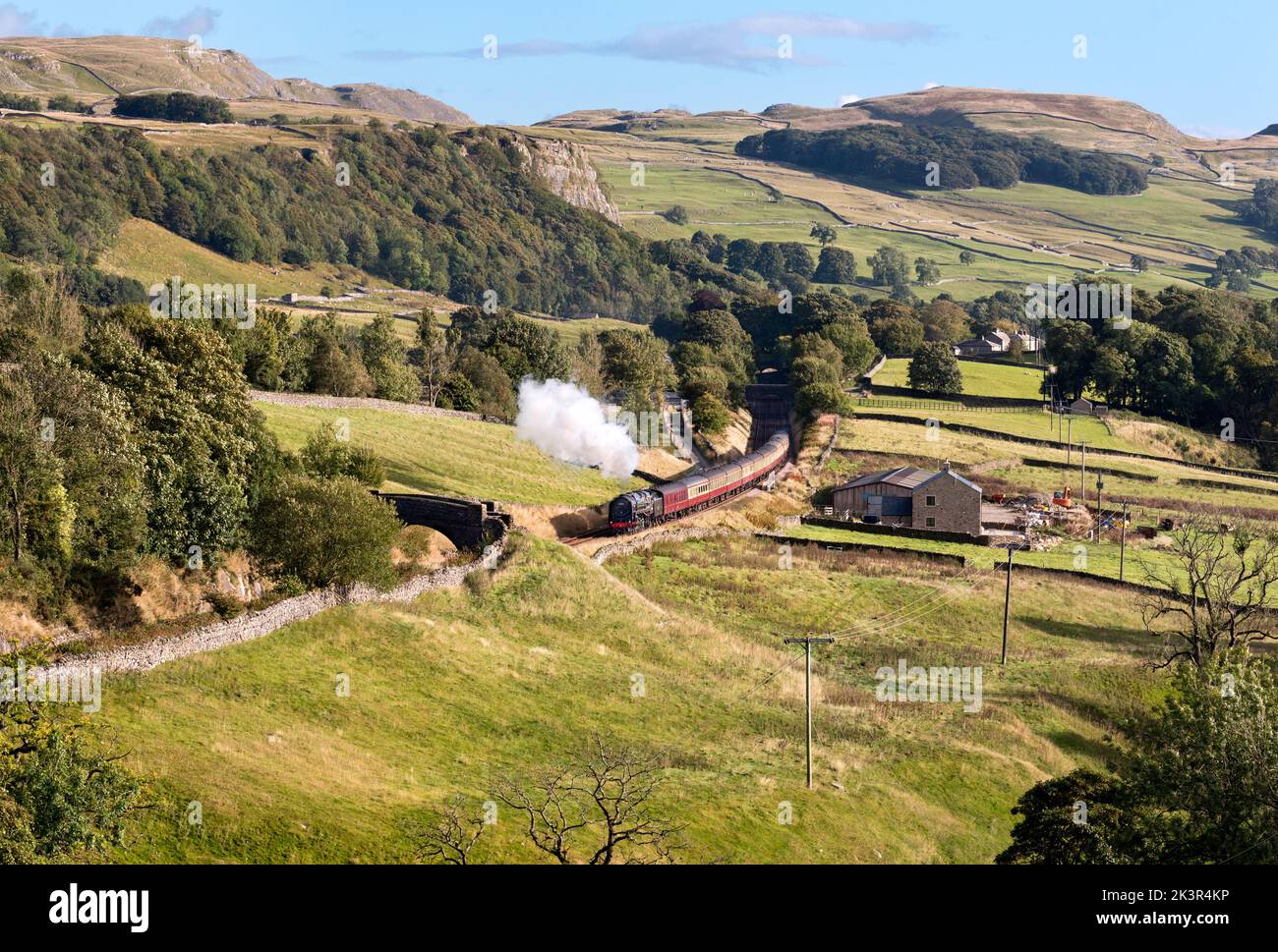 Locomotive 'Britannia' hauls a steam special northward up the steep gradient of the Settle-Carlisle line, Stainforth, Yorkshire Dales National Park Stock Photo