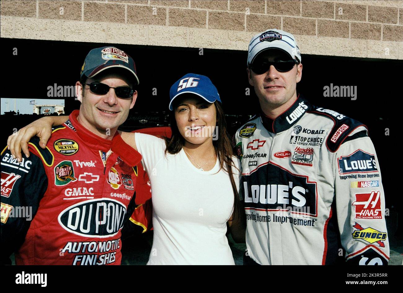 Jeff Gordon, Lindsay Lohan & Jimmie Johnson Film: Herbie Fully Loaded (2005) Characters: Himself,Maggie Peyton & Himself  Director: Angela Robinson 22 June 2005   **WARNING** This Photograph is for editorial use only and is the copyright of DISNEY and/or the Photographer assigned by the Film or Production Company and can only be reproduced by publications in conjunction with the promotion of the above Film. A Mandatory Credit To DISNEY is required. The Photographer should also be credited when known. No commercial use can be granted without written authority from the Film Company. Stock Photo