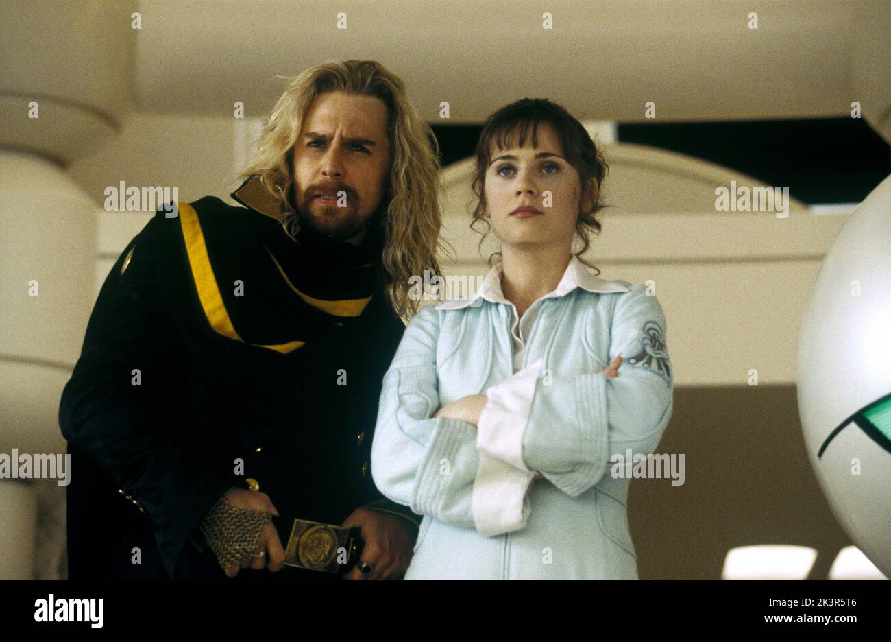 Sam Rockwell & Zooey Deschanel Film: The Hitchhiker'S Guide To The Galaxy (UK/USA 2005) Characters: Zaphod Beeblebrox & Trillian  Director: Garth Jennings 20 April 2005   **WARNING** This Photograph is for editorial use only and is the copyright of DISNEYTOUCHSTONE and/or the Photographer assigned by the Film or Production Company and can only be reproduced by publications in conjunction with the promotion of the above Film. A Mandatory Credit To DISNEYTOUCHSTONE is required. The Photographer should also be credited when known. No commercial use can be granted without written authority from Stock Photo