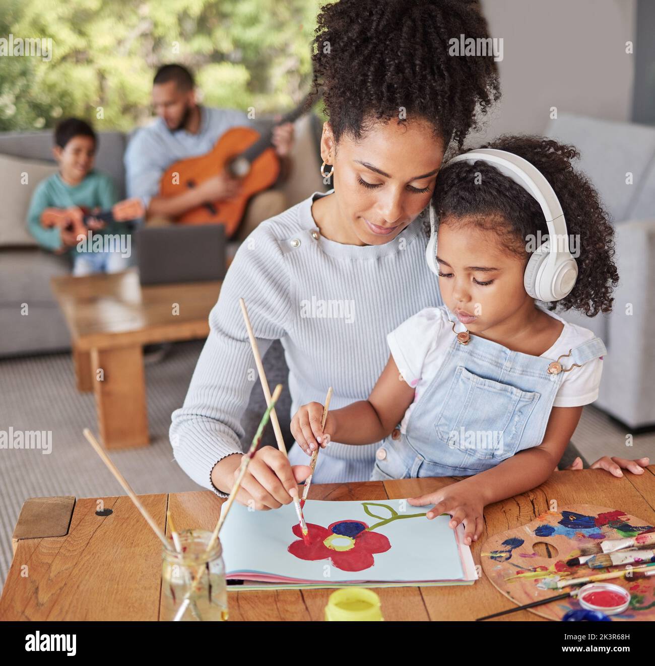 Mother, girl and paint with family learning, together and painting class in home living room. Black woman, kids and art to relax and for education Stock Photo